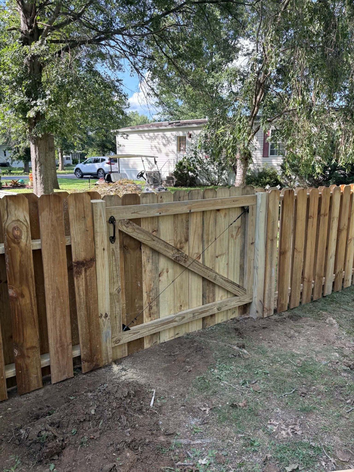 Wood privacy gate built into a fence line