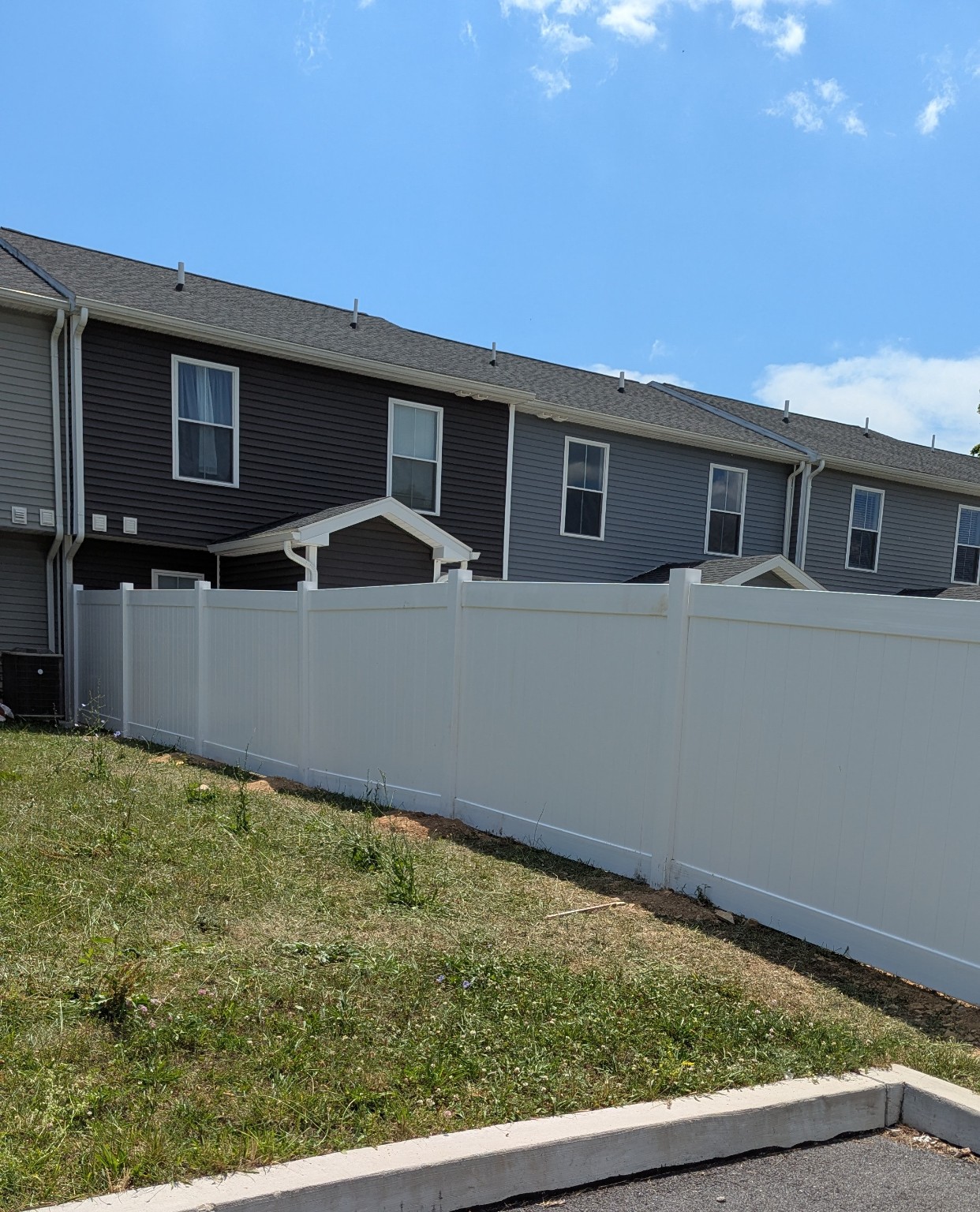 Completed Pitboss white vinyl privacy fence