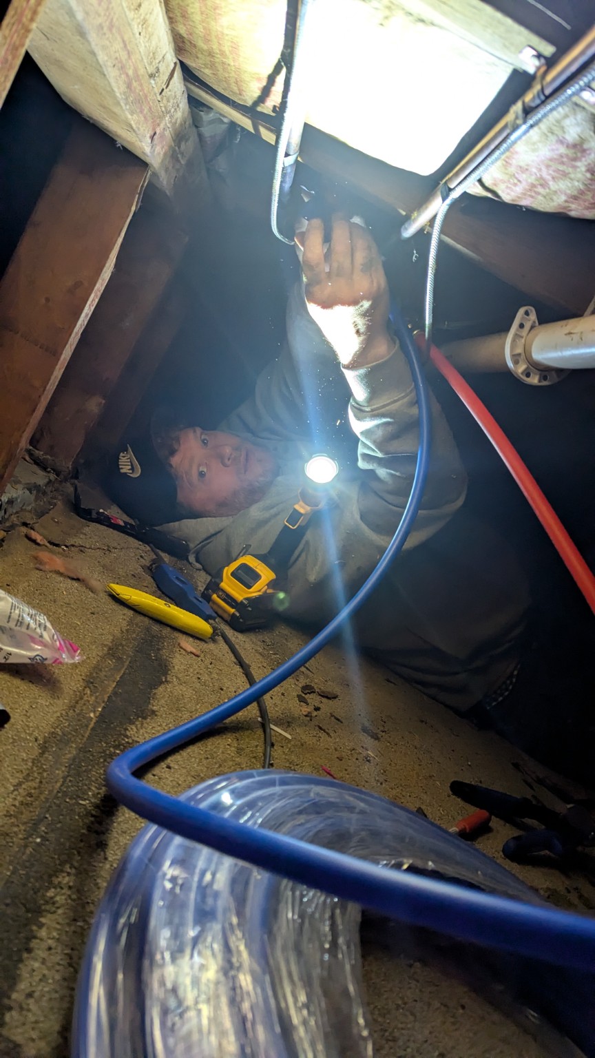 Pitboss working in a tight crawl space