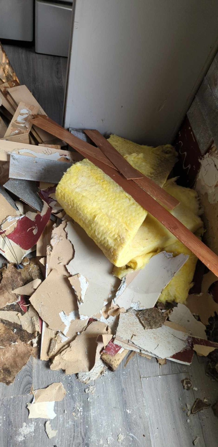 Drywall insulation trim and renovation debris ready for cleanup